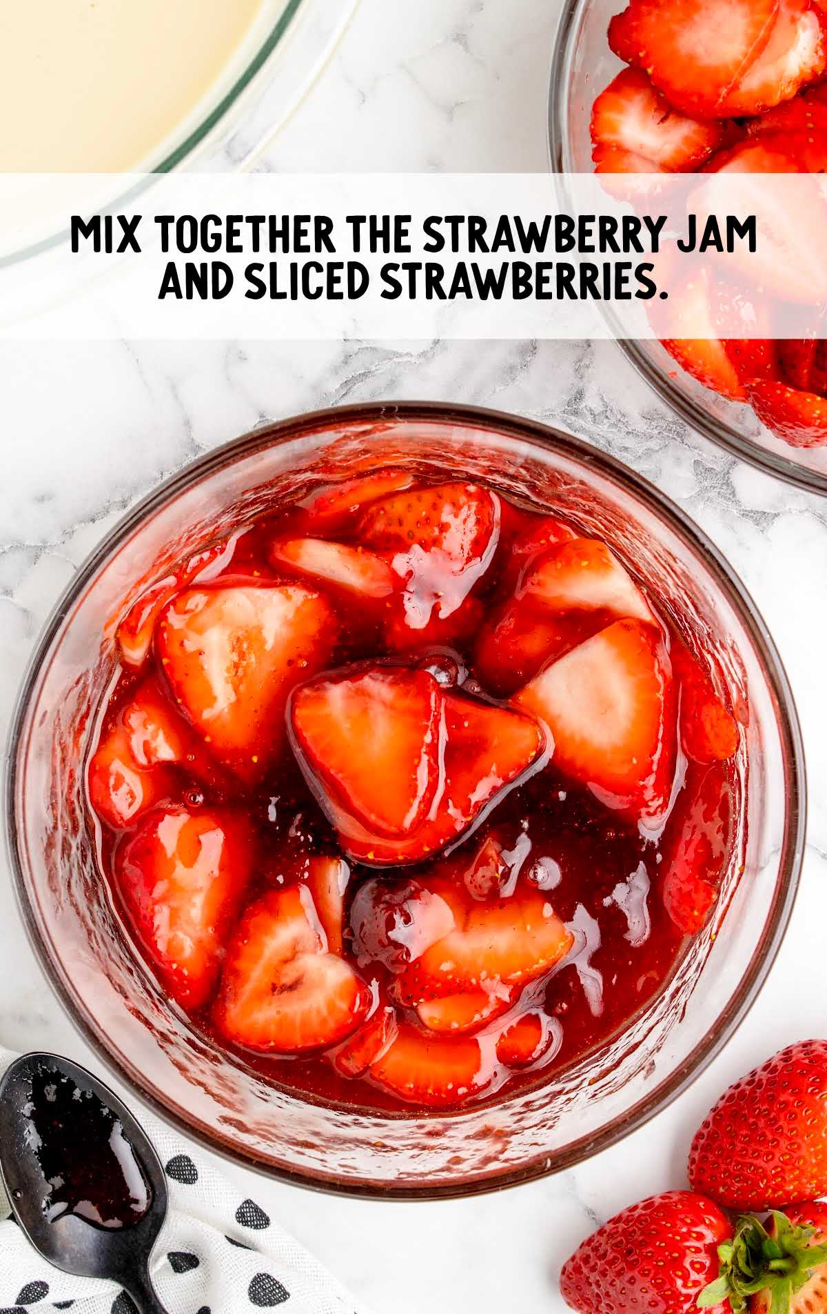 strawberry jam and sliced strawberries mixed together in a bowl