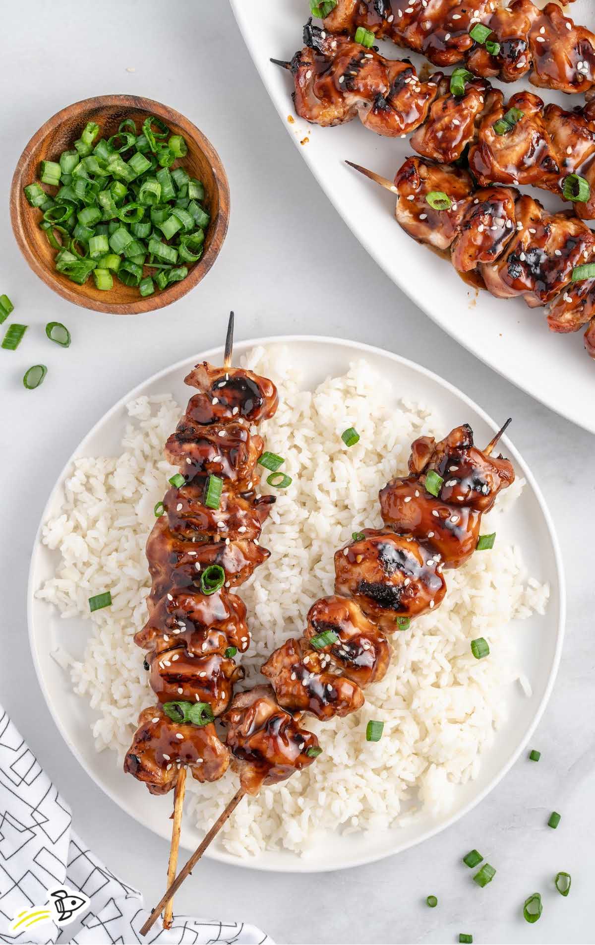 overhead shot of Teriyaki Chicken Skewers on a plate with white rice