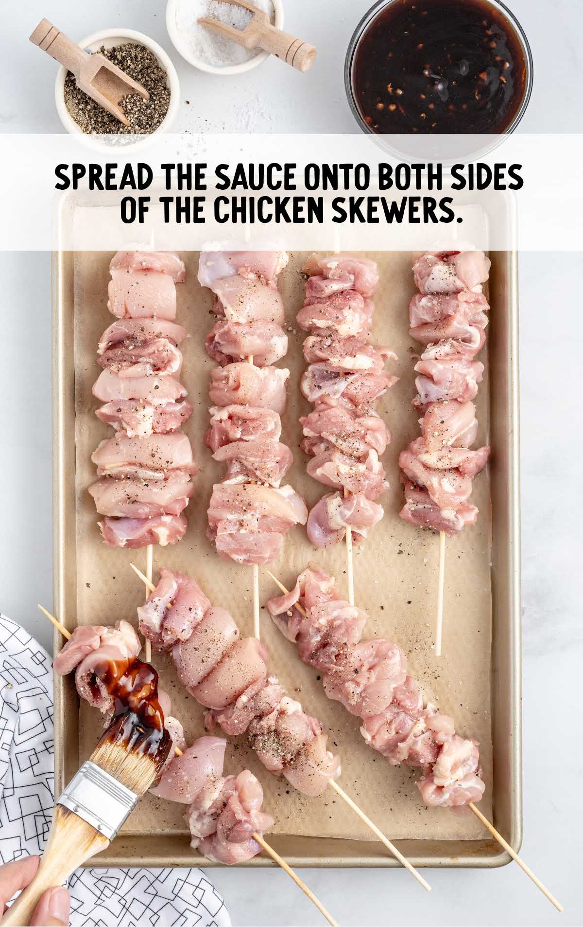 sauce spread on both sides of the chicken skewers