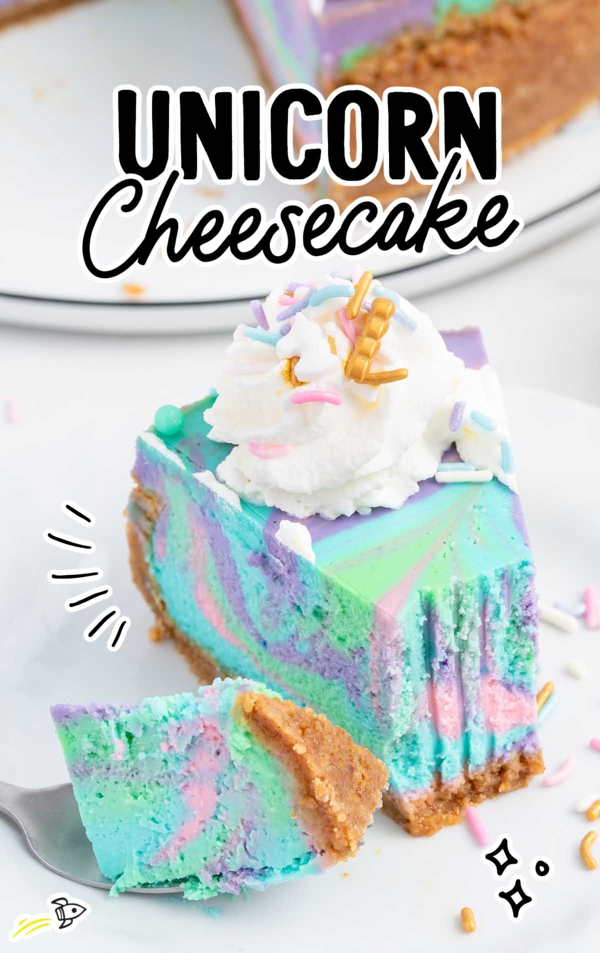 a close up shot of a slice of Unicorn Cheesecake with a piece taken out by a spoon