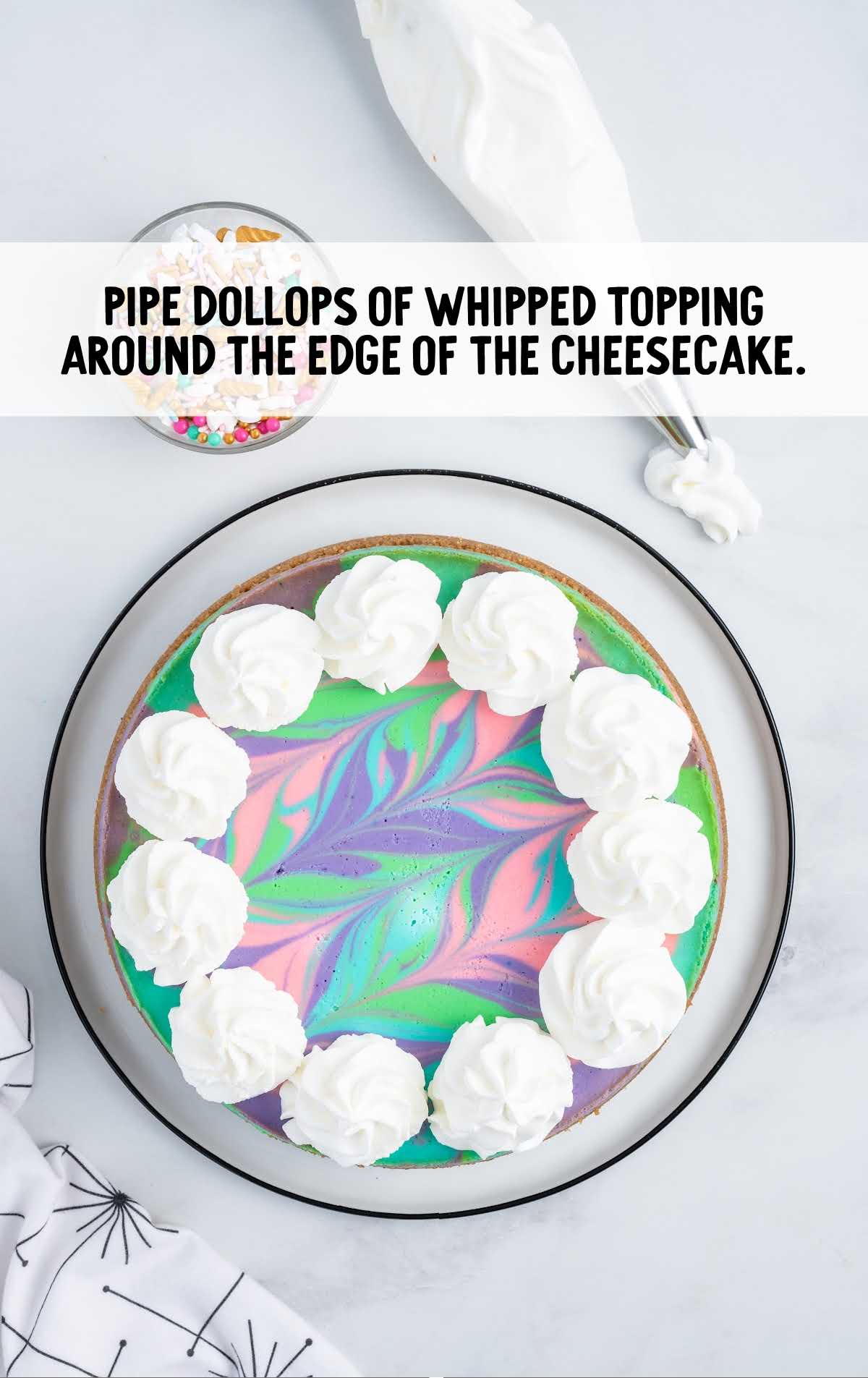 whipped topping dollops around the edges of the cheesecake