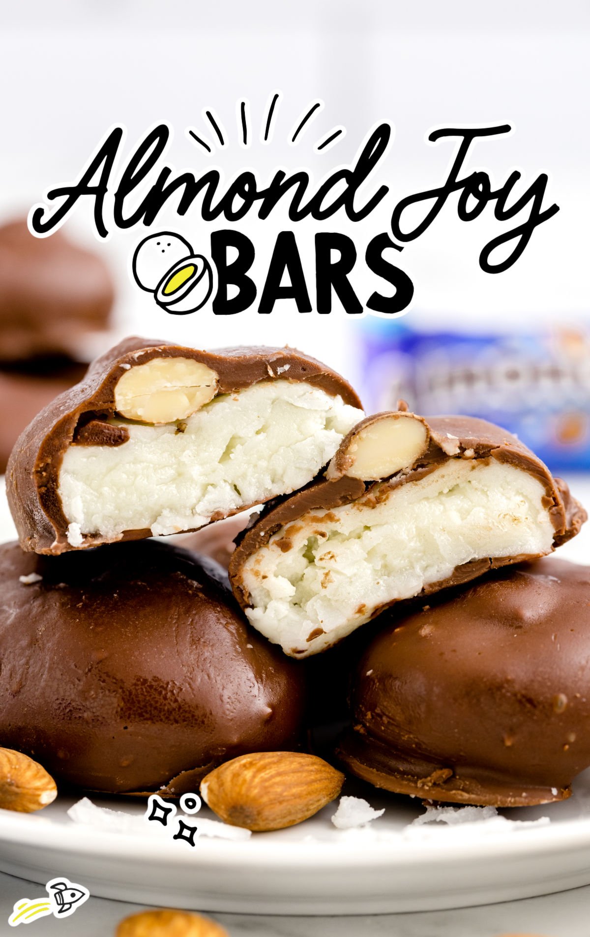 a close up shot of the inside layers of almond joy bars on a white plate