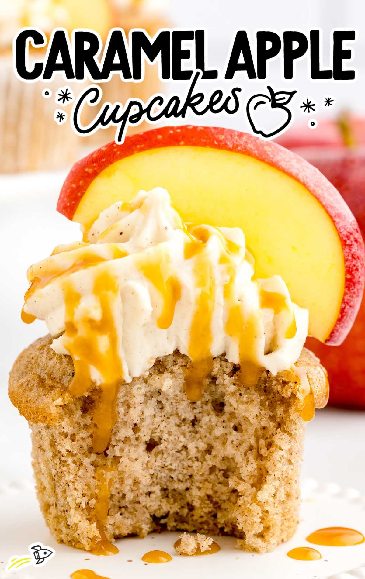 a close up shot of a Caramel Apple Cupcake on a stand with a bite taken out of it
