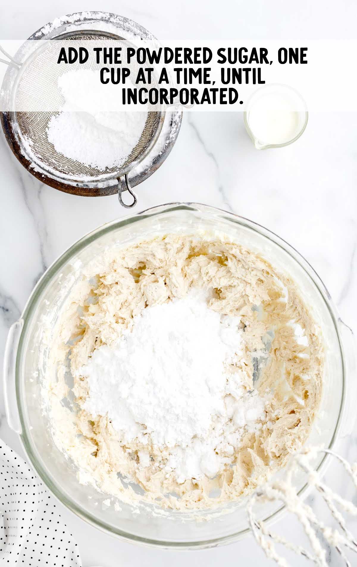 powdered sugar added to the cream cheese mixture in a bowl