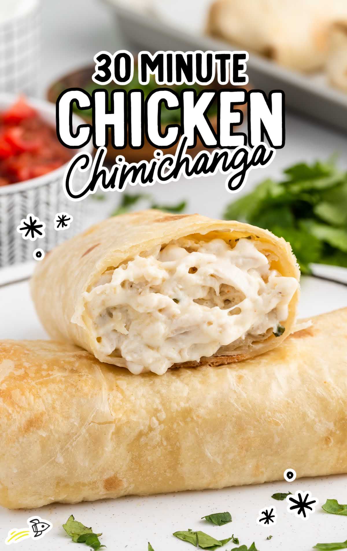 a close up shot of a couple of 30 Minute Chicken Chimichangas on a plate with one on top of the other
