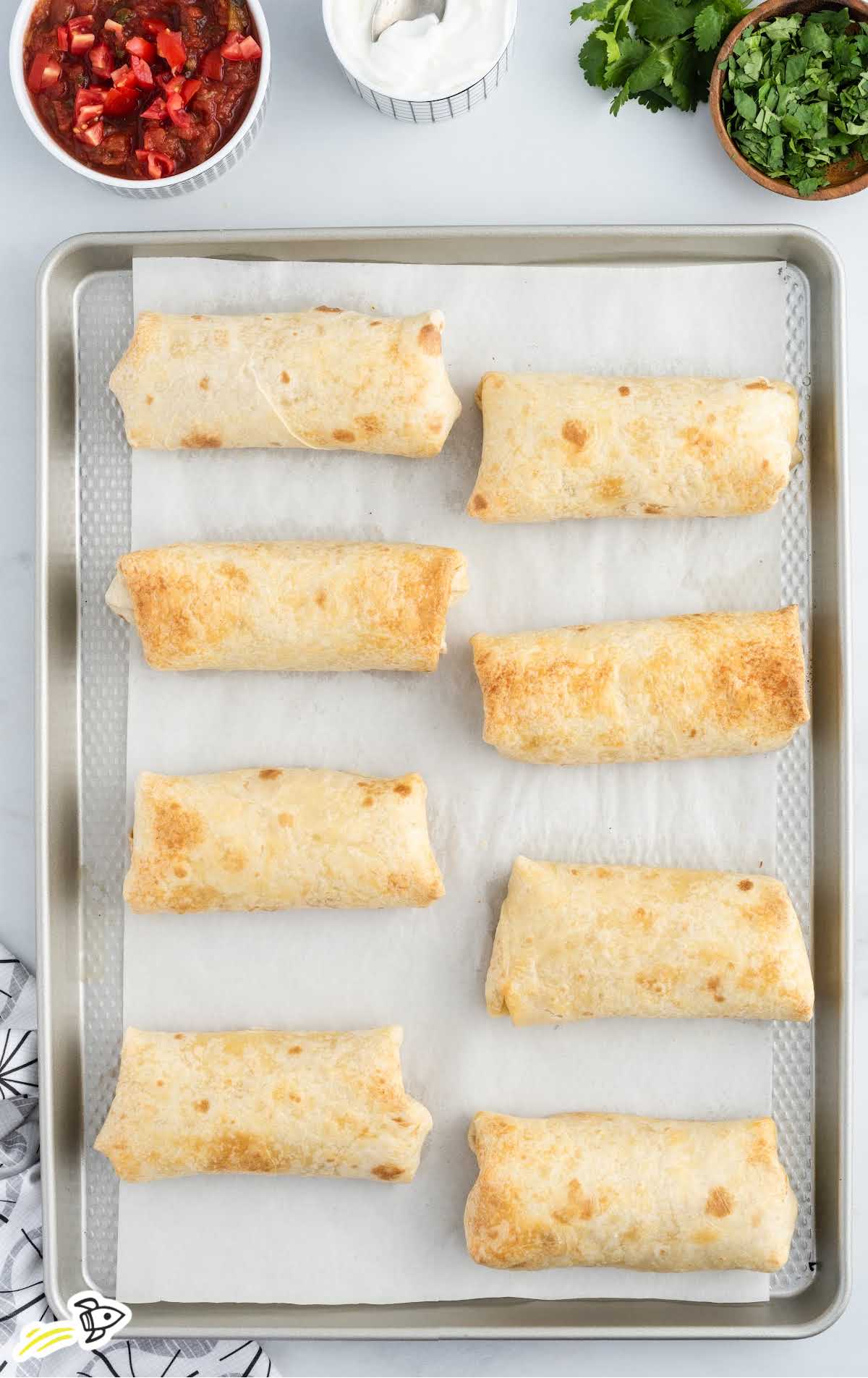 overhead shot of Chicken Chimichangas baked on a baking pan