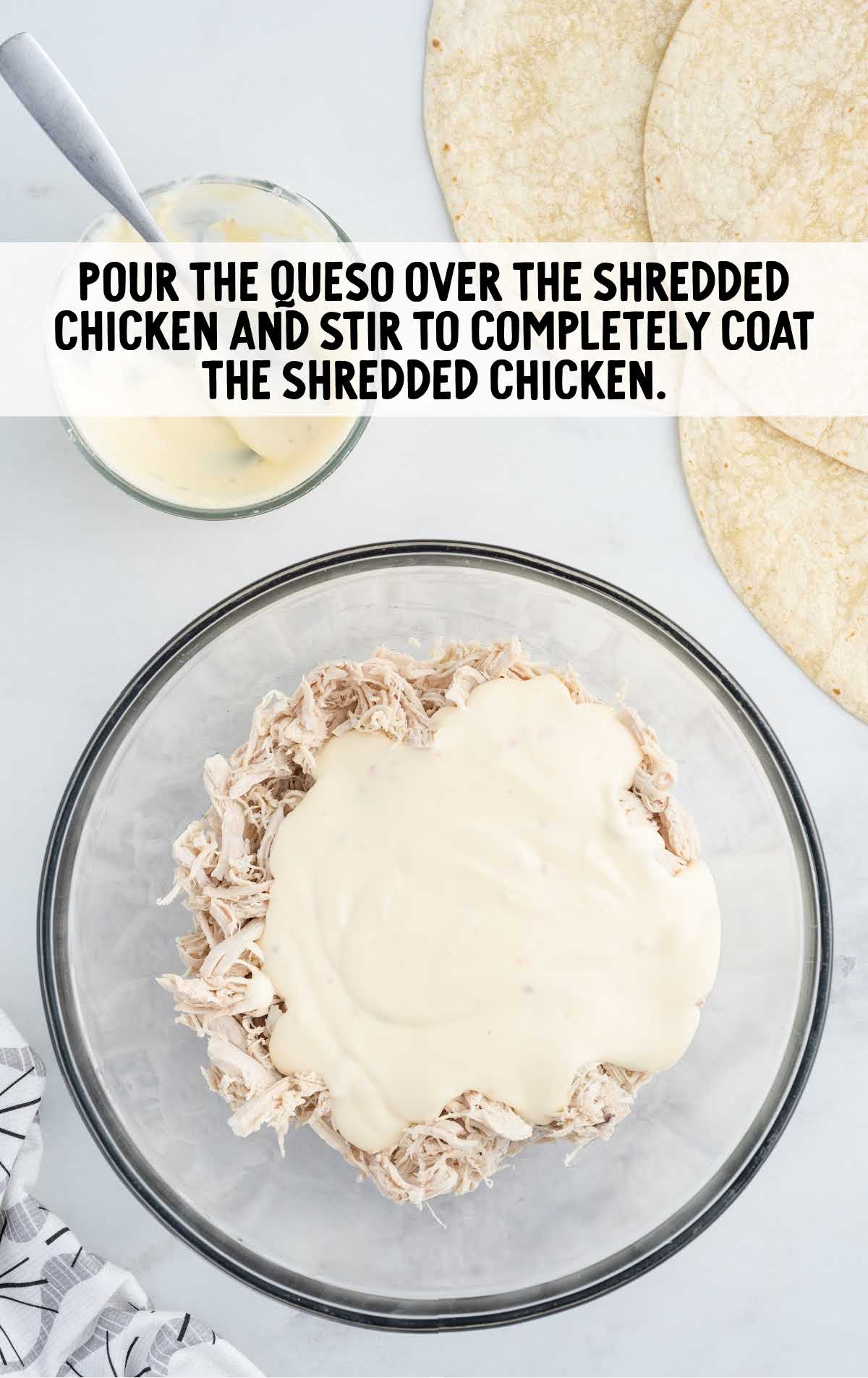 queso poured over the shredded chicken and stirred together