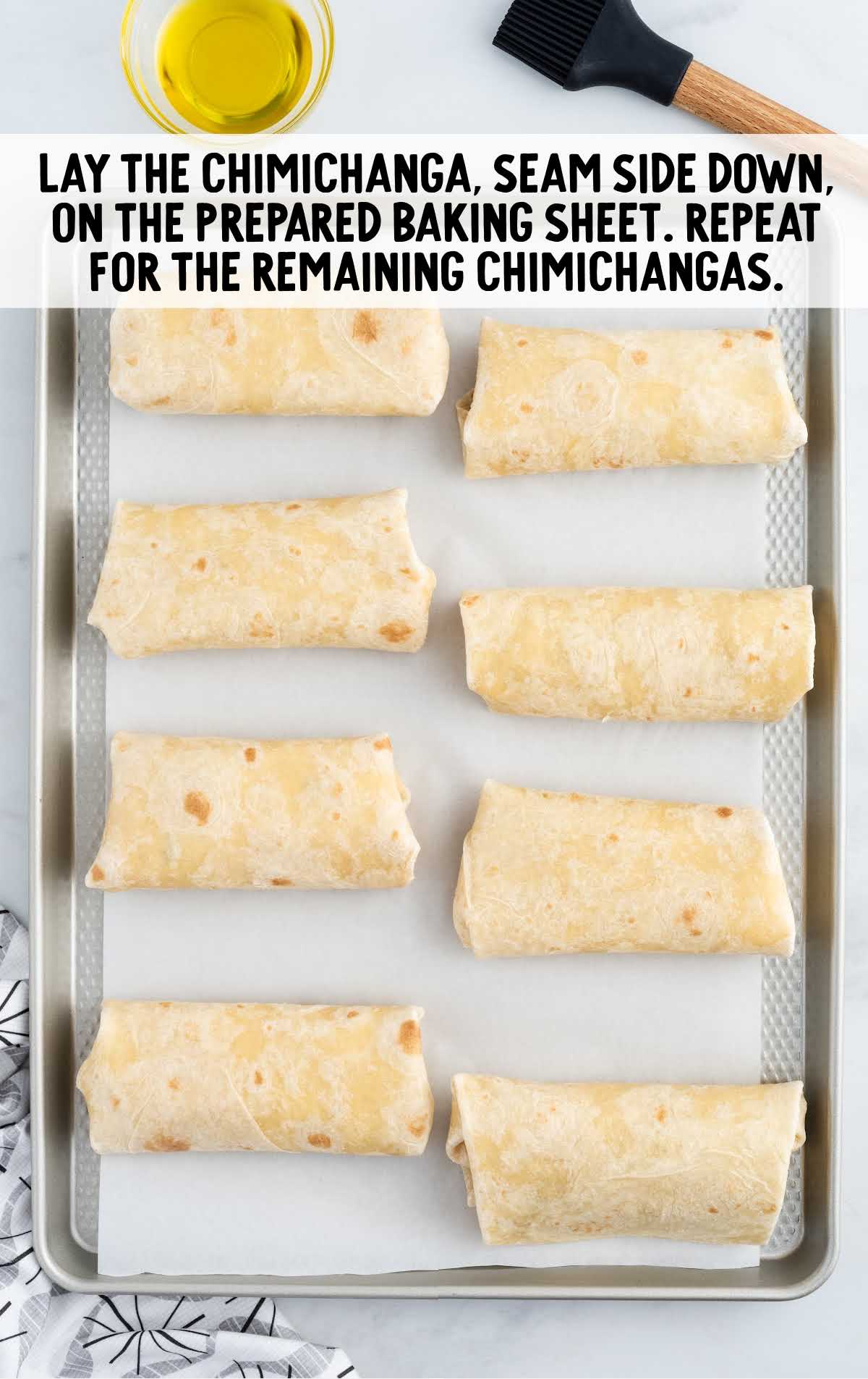 chimichangas laid seam down on a baking dish