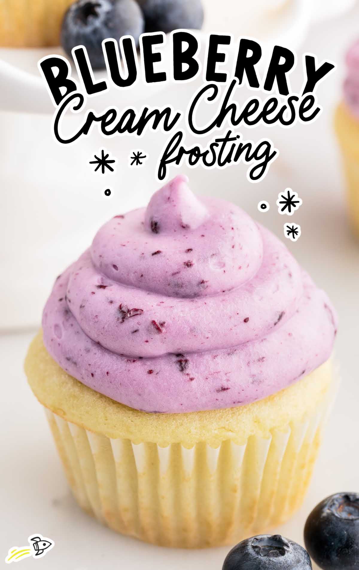 a close up shot of Blueberry Cream Cheese Frosting on a cupcake