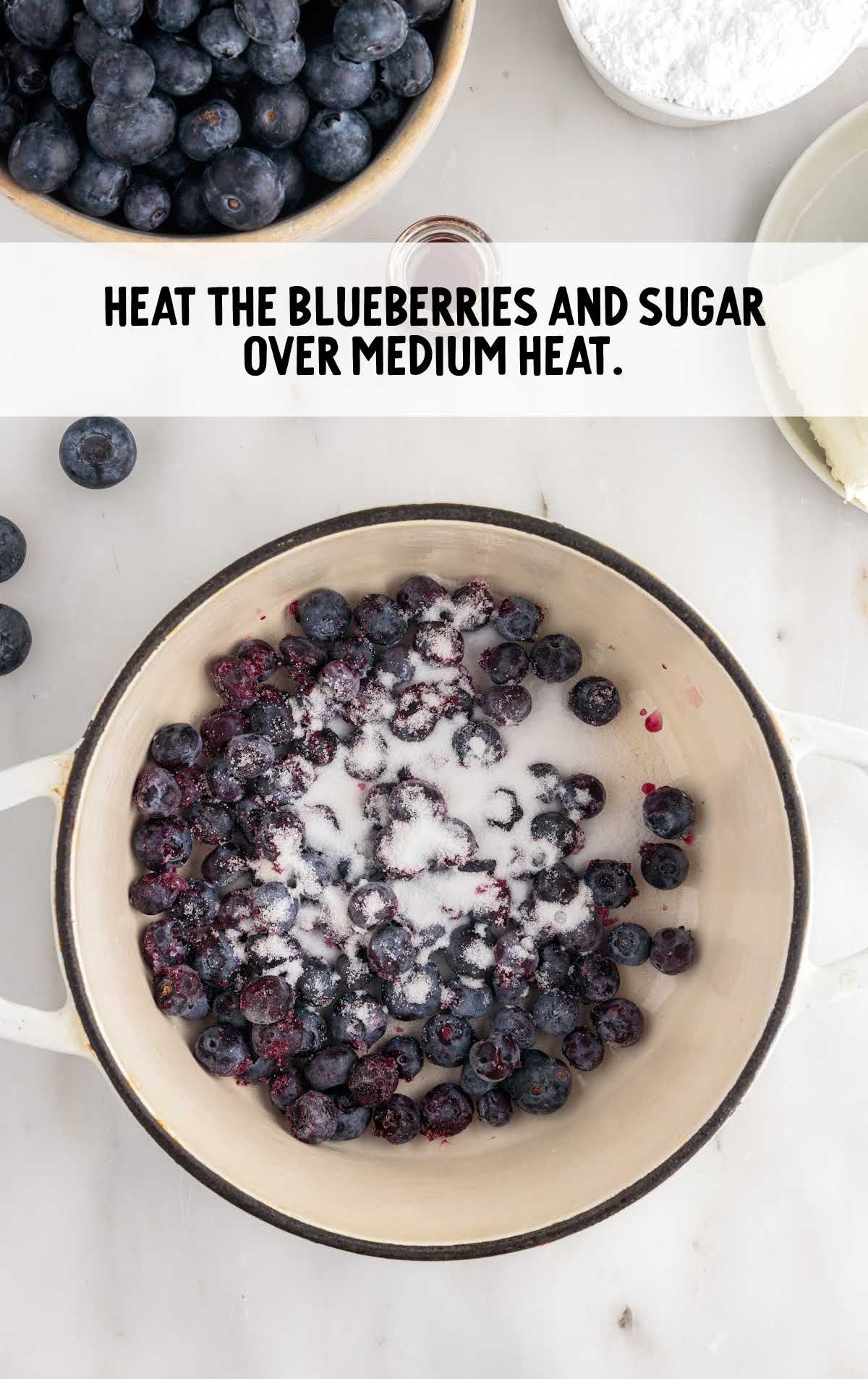 blueberry and sugar heated up in a pot