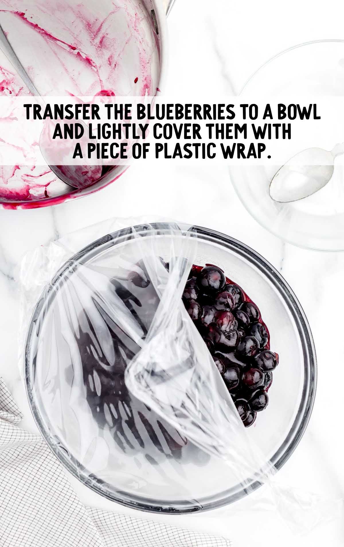 blueberries transferred to a bowl and covered in a plastic wrap