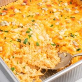 a close up shot of Buffalo Chicken Casserole with a spoon grabbing a piece