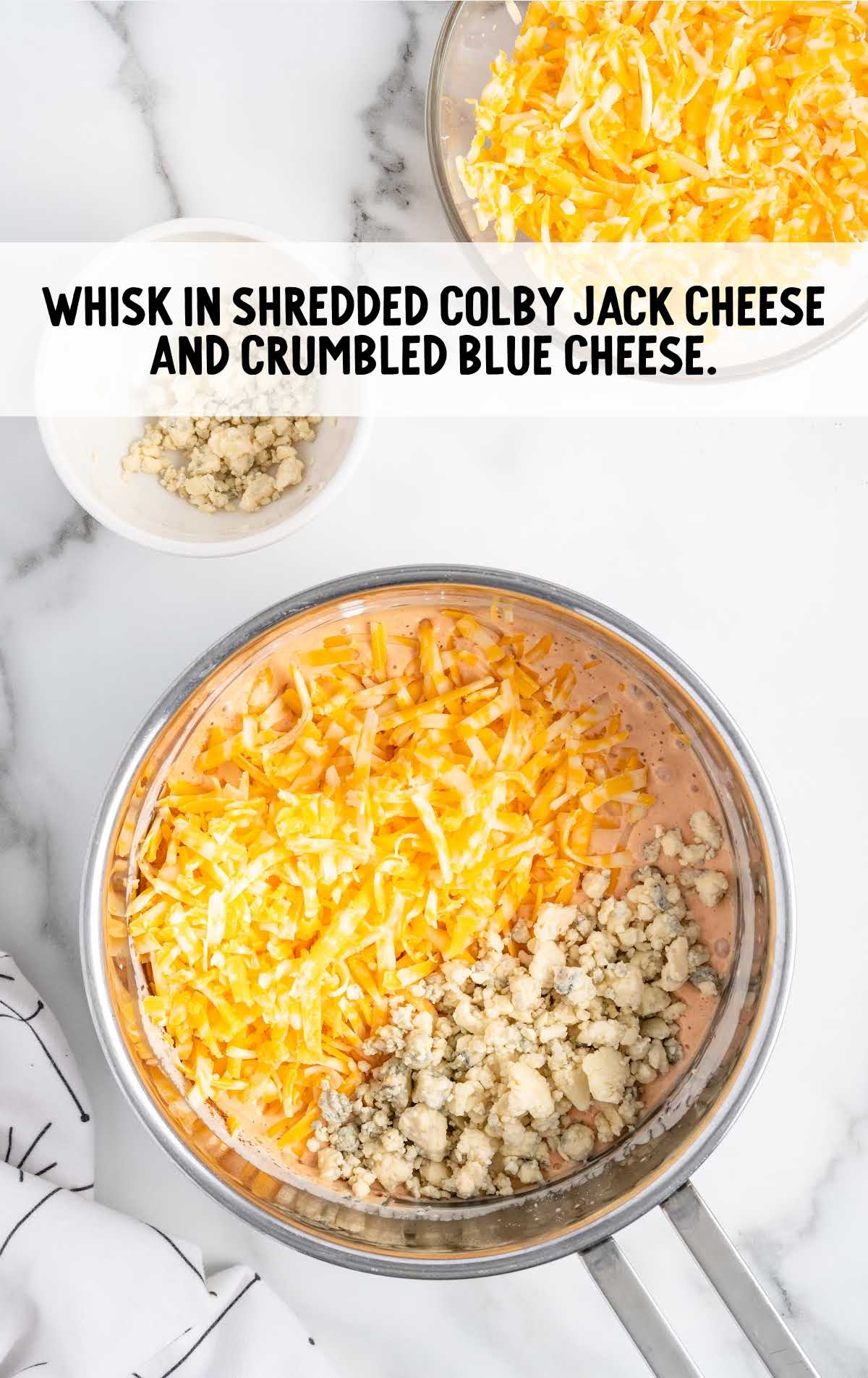 shredded colby jack cheese and crumbled blue cheese whisked