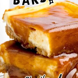 a close up shot of Caramel Cheesecake Bars stacked on top of each other