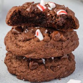 a close up shot of Chocolate Peppermint Cookies stacked on top of each other with one having a bite out of one