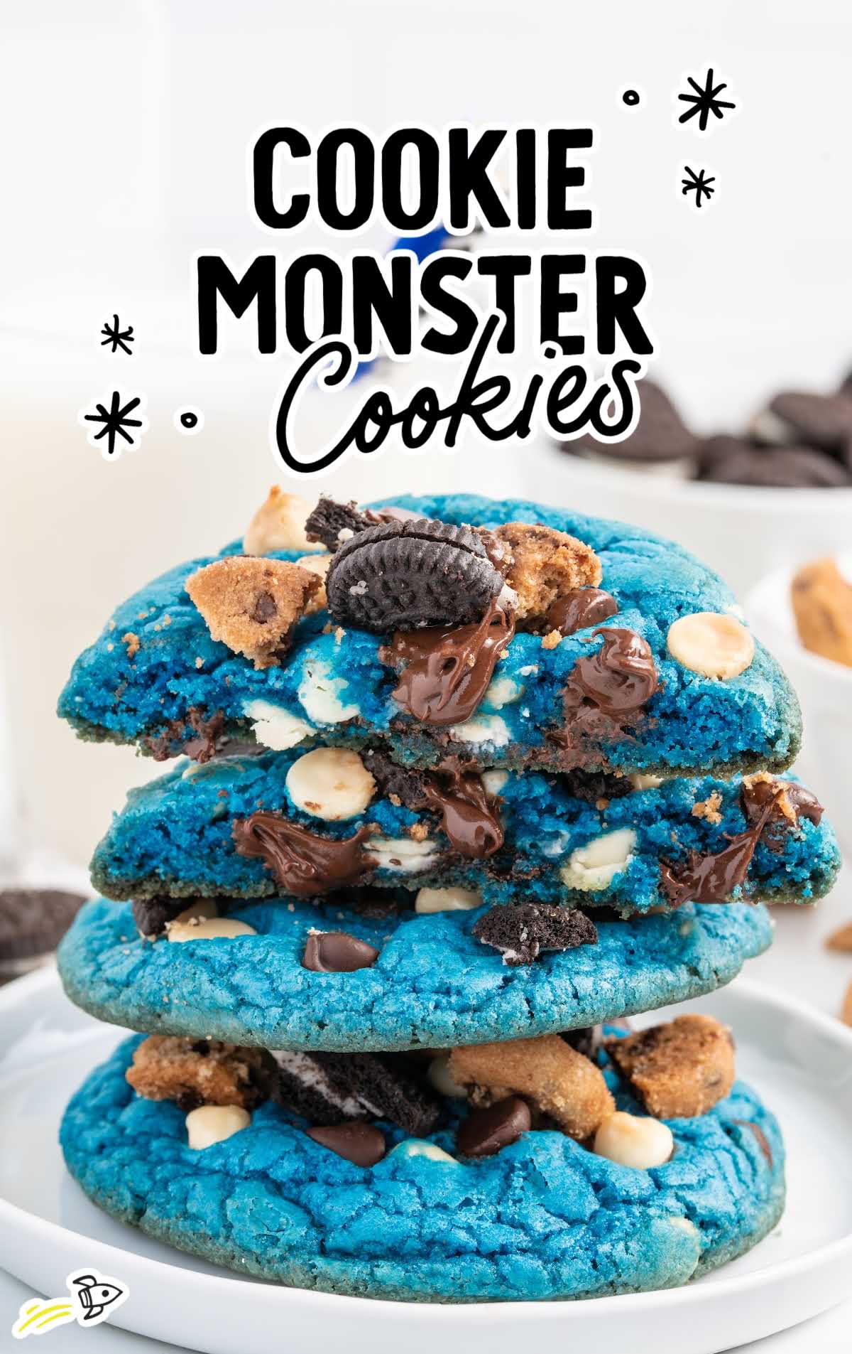 a close up shot of Cookie Monster Cookies stacked on top of each other with one cookie split in half