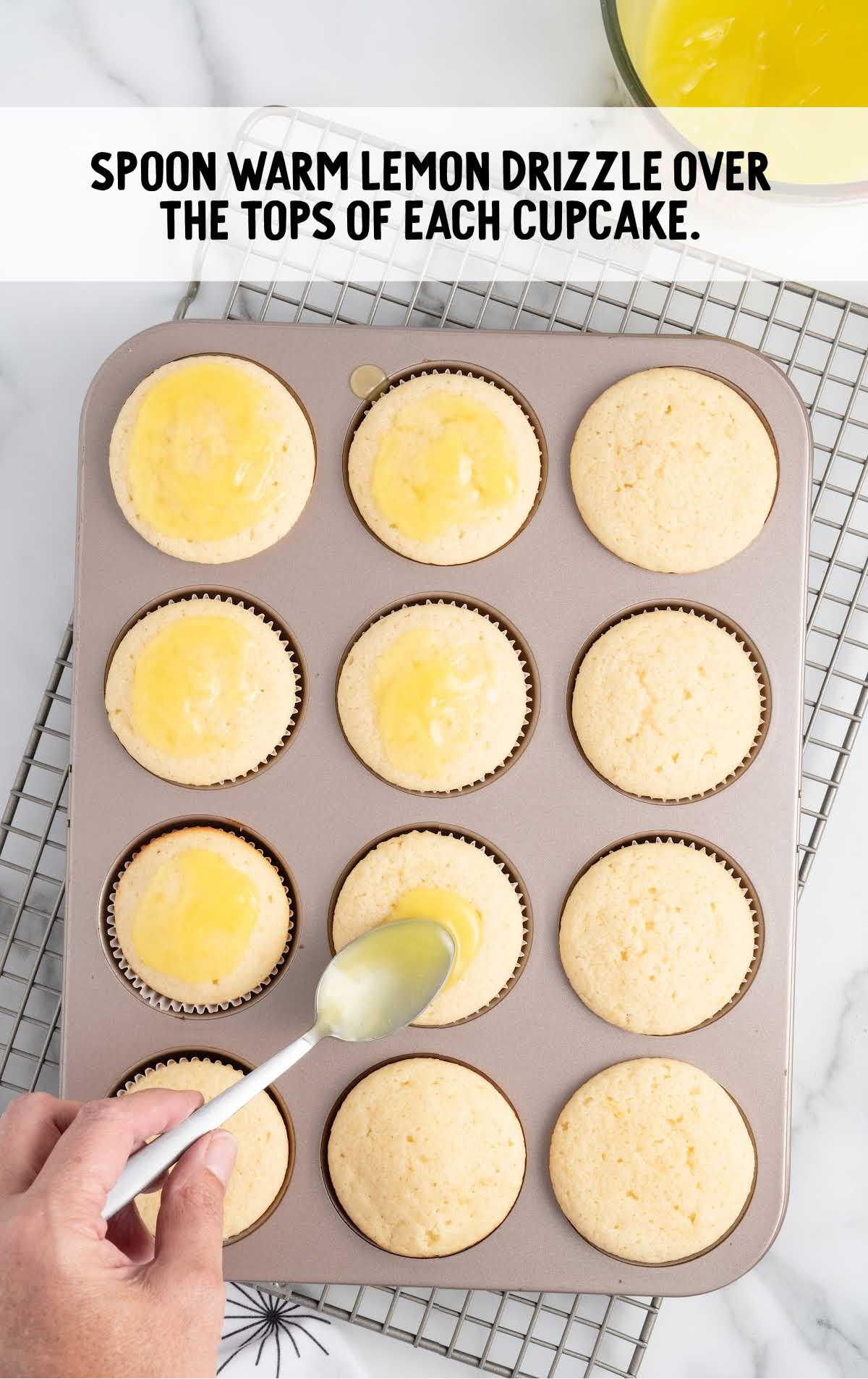 lemon drizzle spooned over the top of the cupcakes