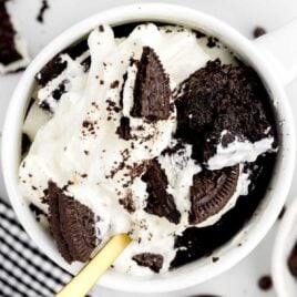 a overhead shot of Oreo Cake in a Mug with a spoon