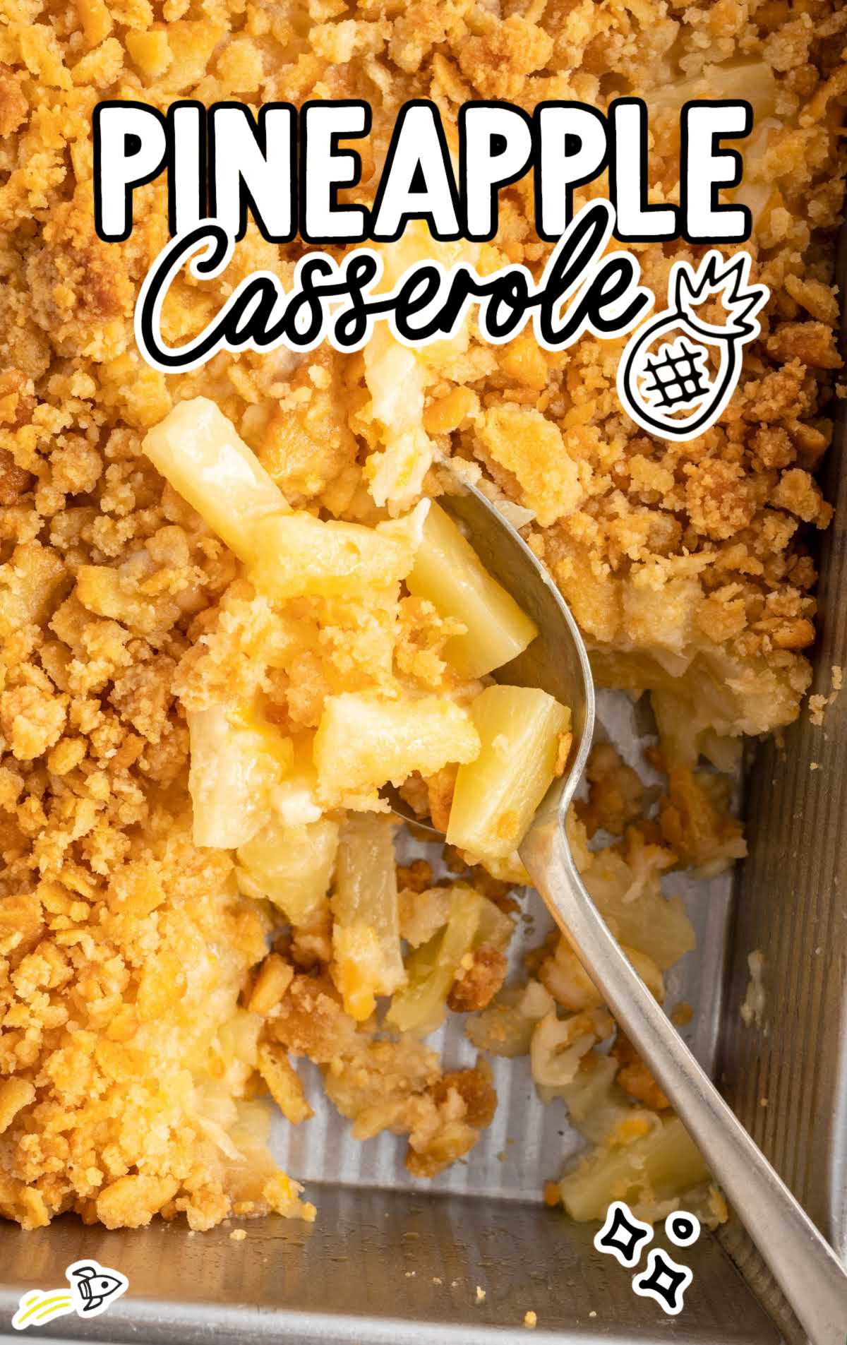 a overhead shot of Pineapple Casserole with a spoon grabbing a piece