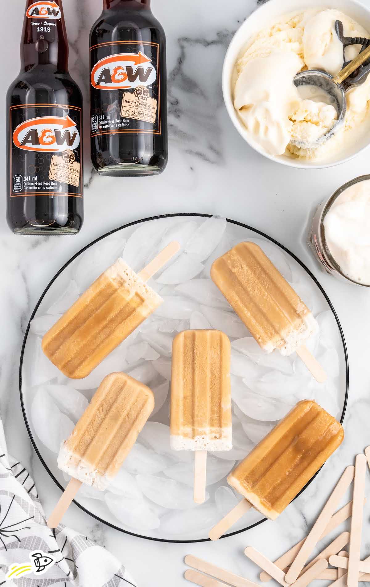 overhead shot of Root Beer Popsicles laid out on a glass plate