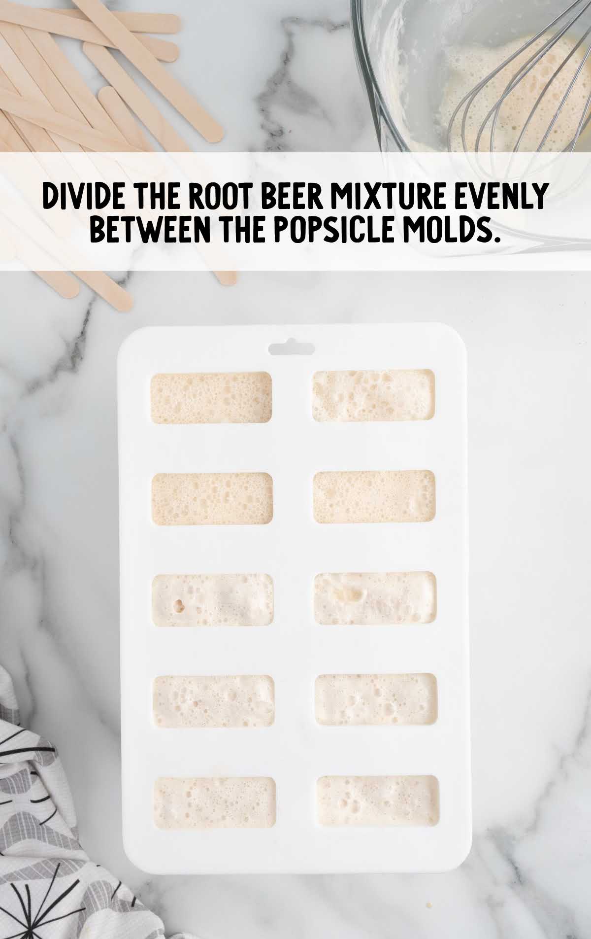root beer mixture divided between the popsicle molds