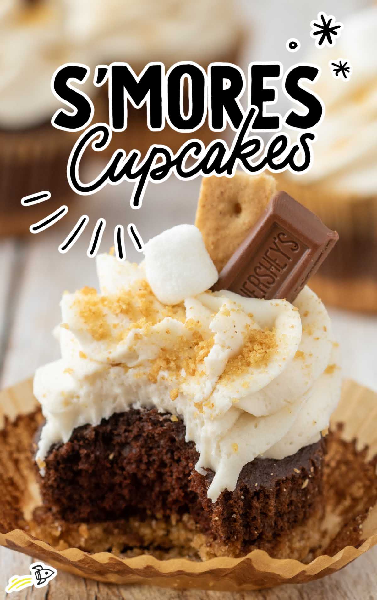 a close up shot of a S’mores Cupcake with a bite taken out of it