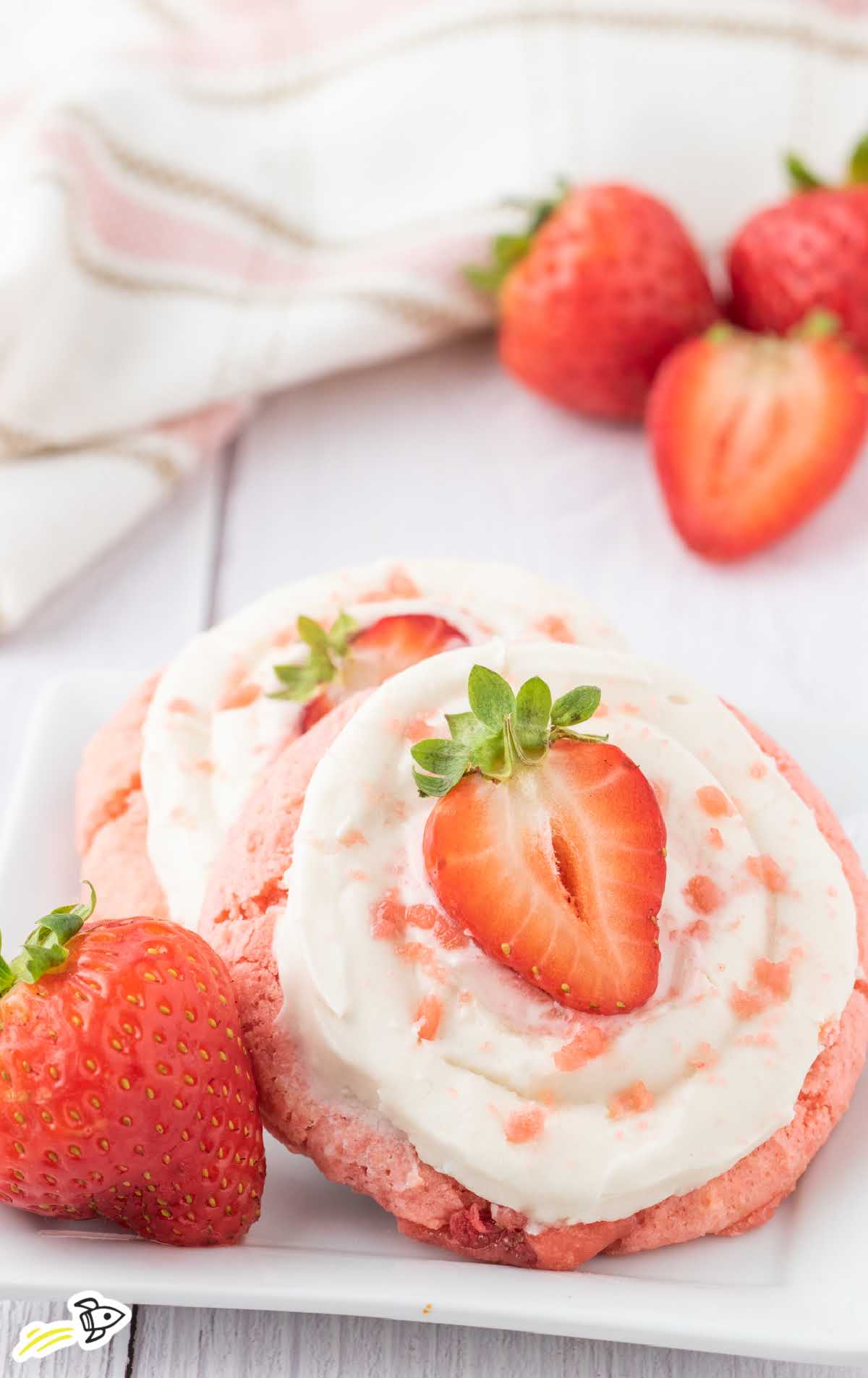 a close up shot of Strawberry Cookies with Cream Cheese Frosting on a plate
