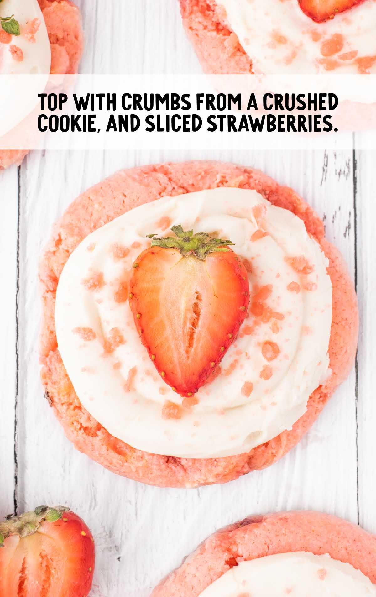 crumbs from crushed cookie topped on top with a sliced strawberry