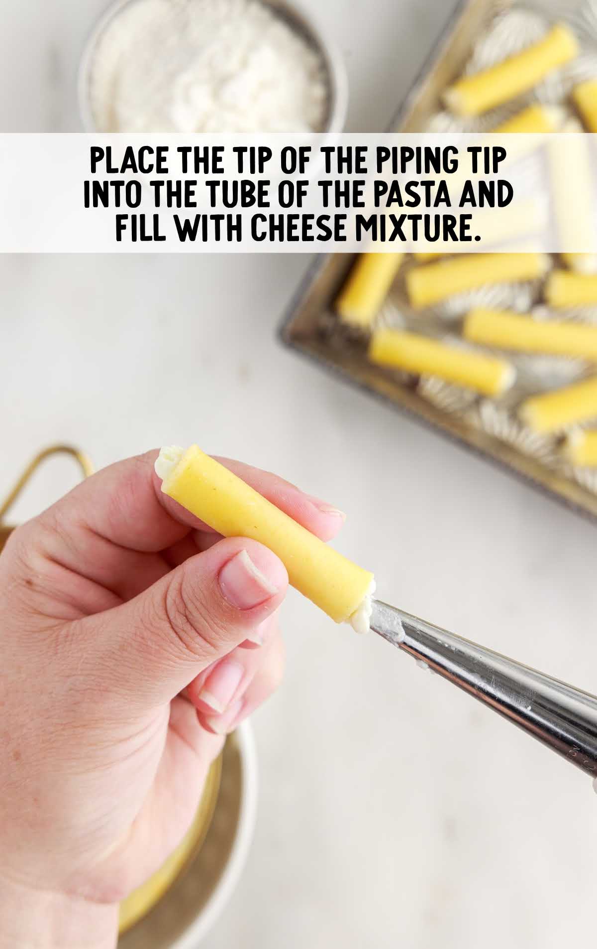 piping tip placed into the tub of the pasta and fill with cheese mixture