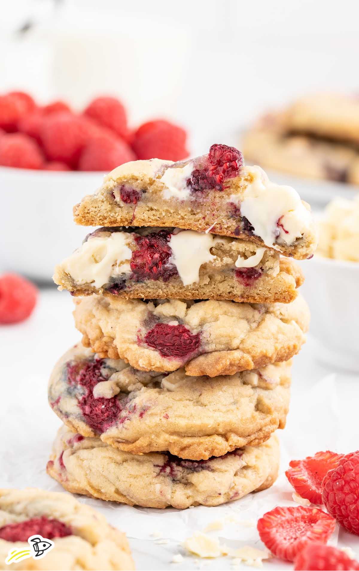 close up shot of White Chocolate Raspberry Cookies stacked on top of each other with one split in half