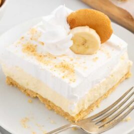 a close up shot of a piece of Banana Cheesecake Bars