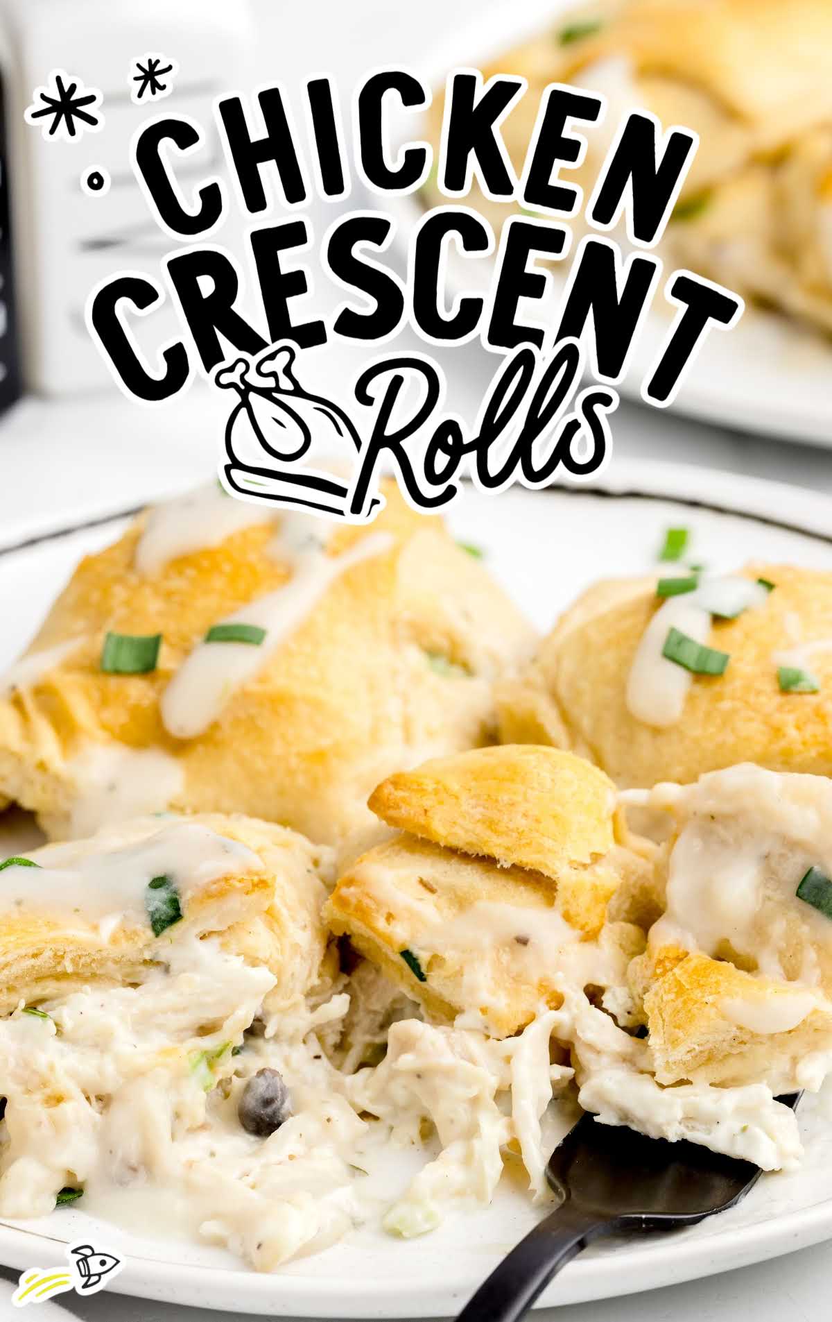 a close up shot of Chicken Crescent Rolls on a plate with a fork grabbing a piece
