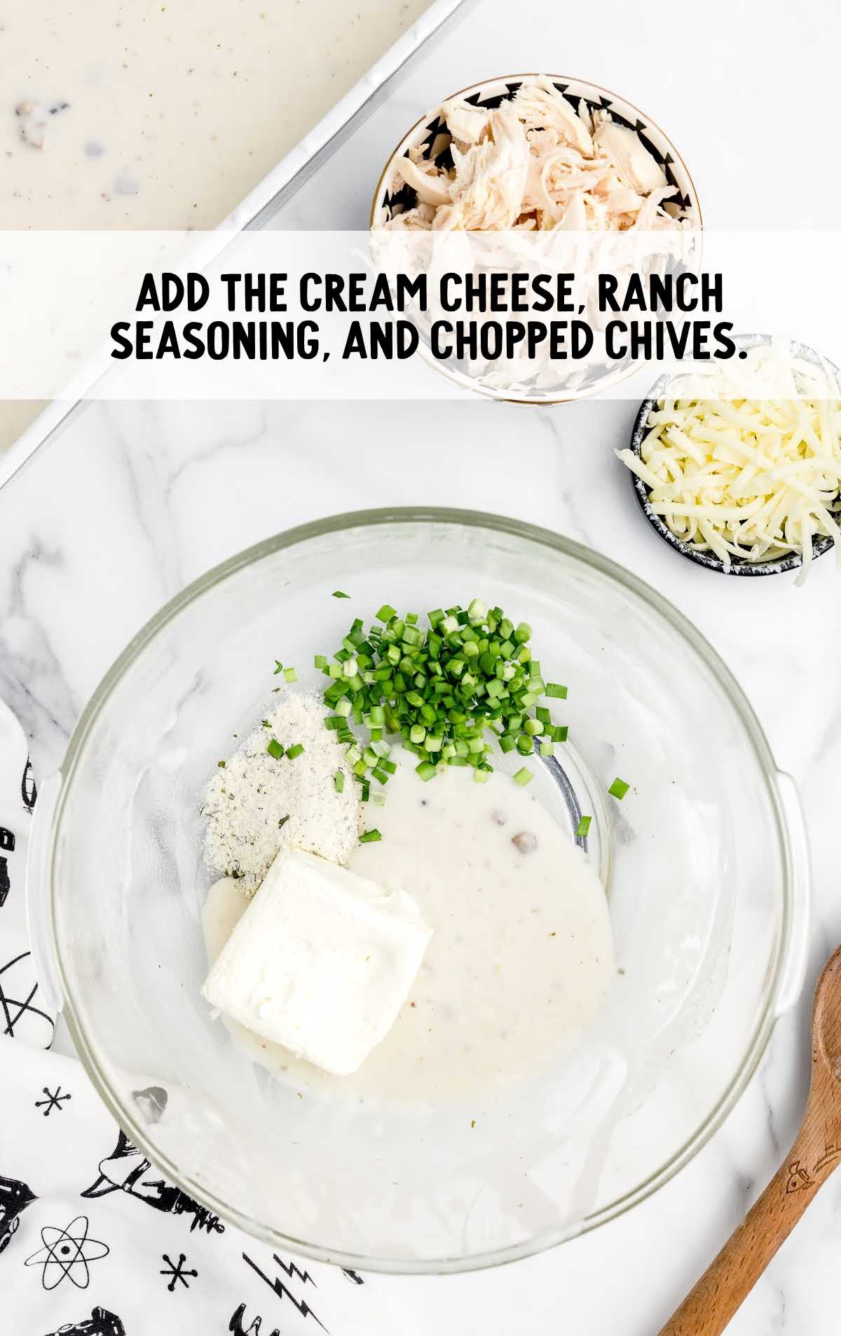 cream cheese, ranch seasoning, and chopped chives added to a bowl