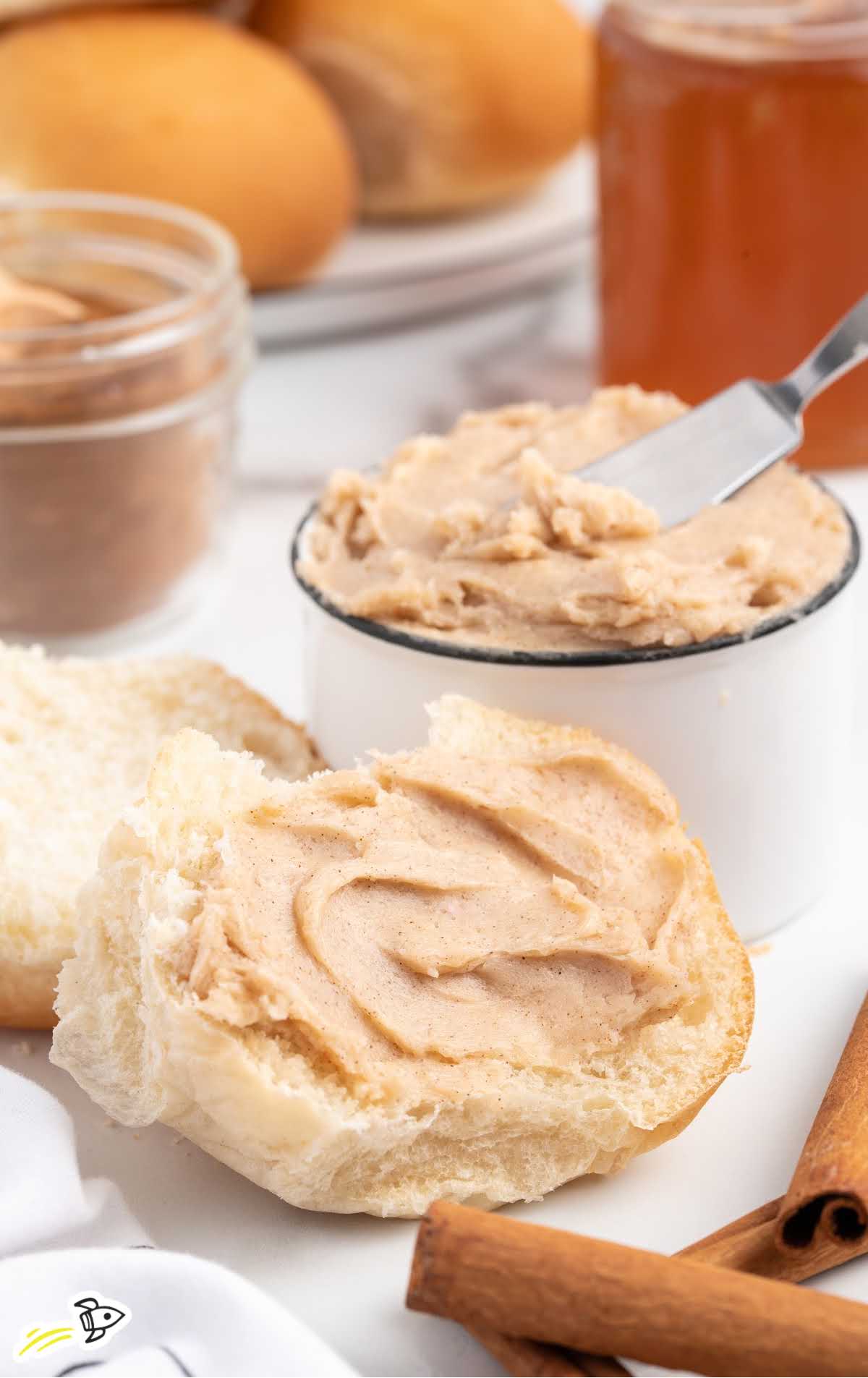 a close up shot of a jar filled with Cinnamon Butter with a butter knife