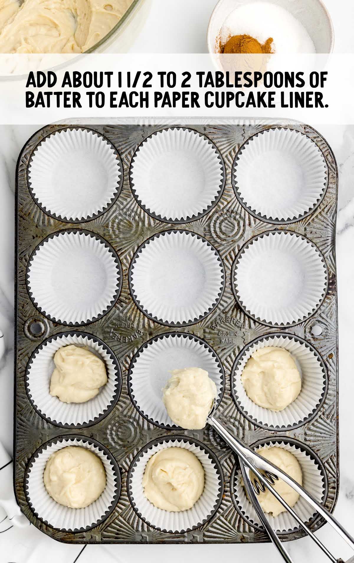 batter added to each paper cupcake liner