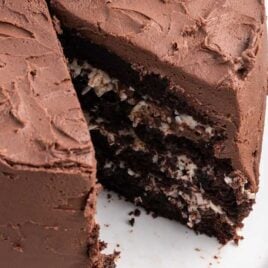 a close up shot of a Mounds Cake with slices taken out