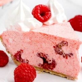 a close up shot of a slice of No Bake Raspberry Pie on a plate