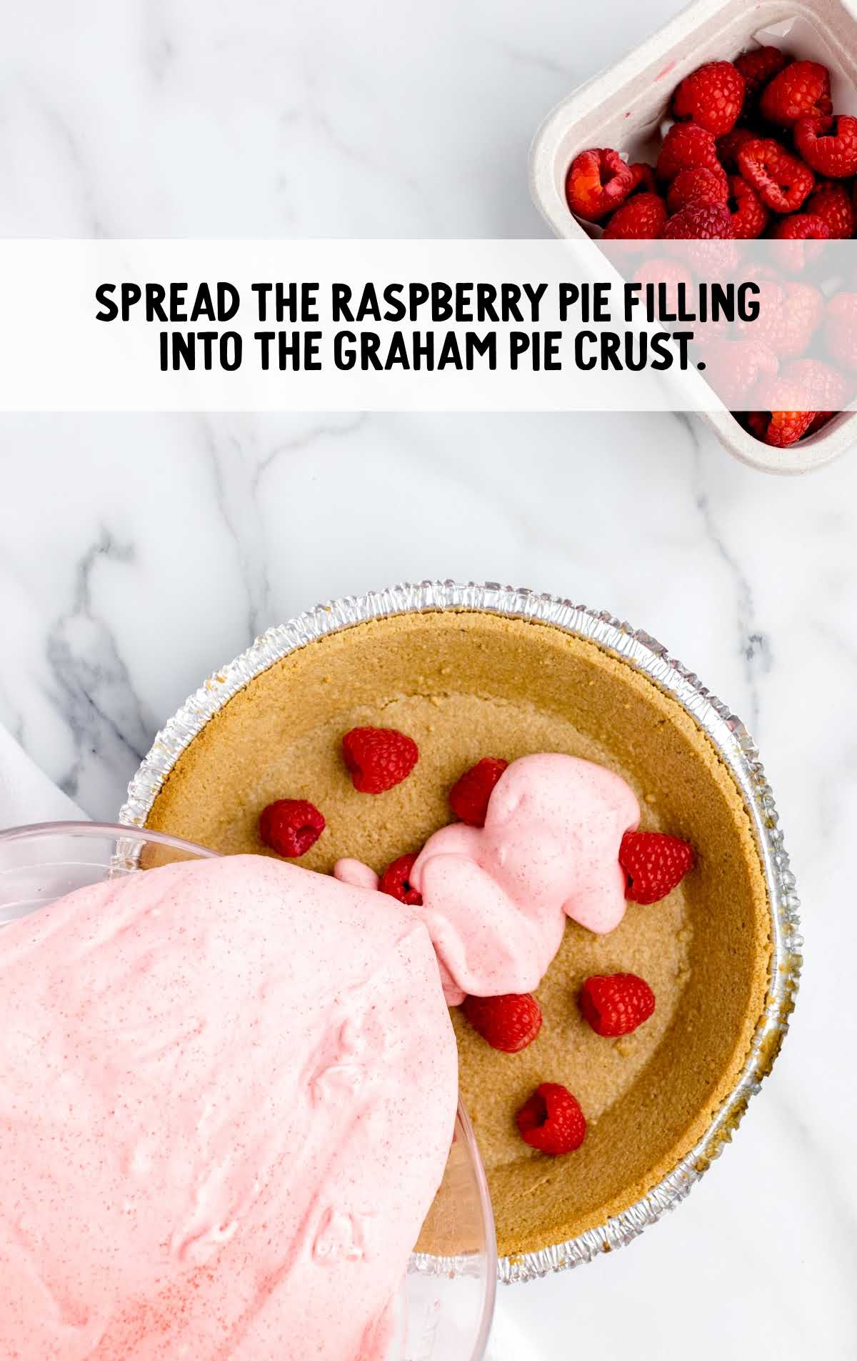 raspberry pie filling spread into the graham crust