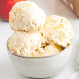 close up shot of scoops of peach ice cream in a bowl