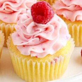 a close up shot of Raspberry Cupcakes on a plate