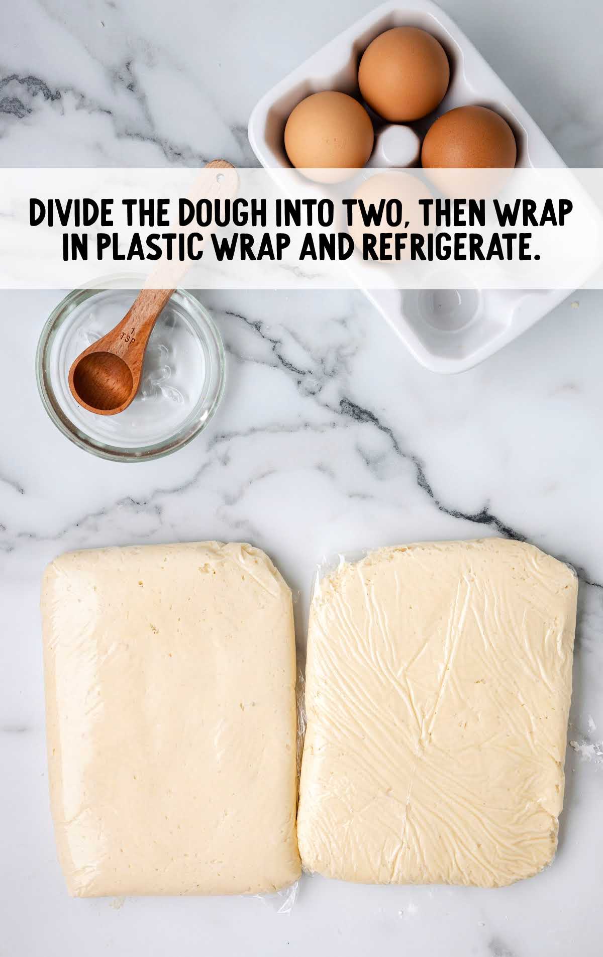 dough divided into two and then wrapped in a plastic wrap