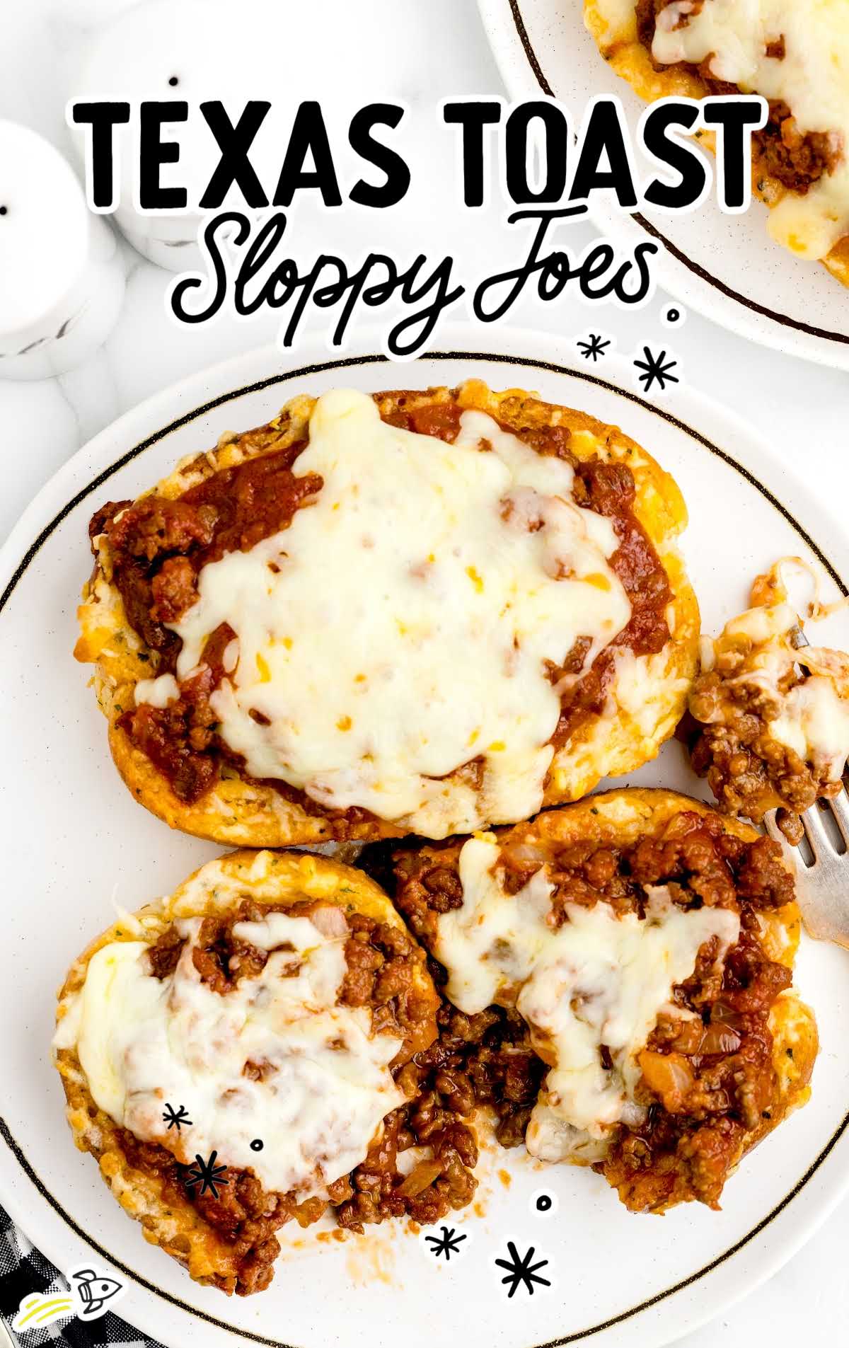 overhead shot of Texas Toast Sloppy Joes on a plate with one having a bite taken out of it