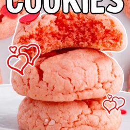 a close up shot of Valentine Cookies stacked on top of each other with one having a bite taken out of it