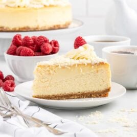 a close up shot of a slice of White Chocolate Cheesecake on a plate
