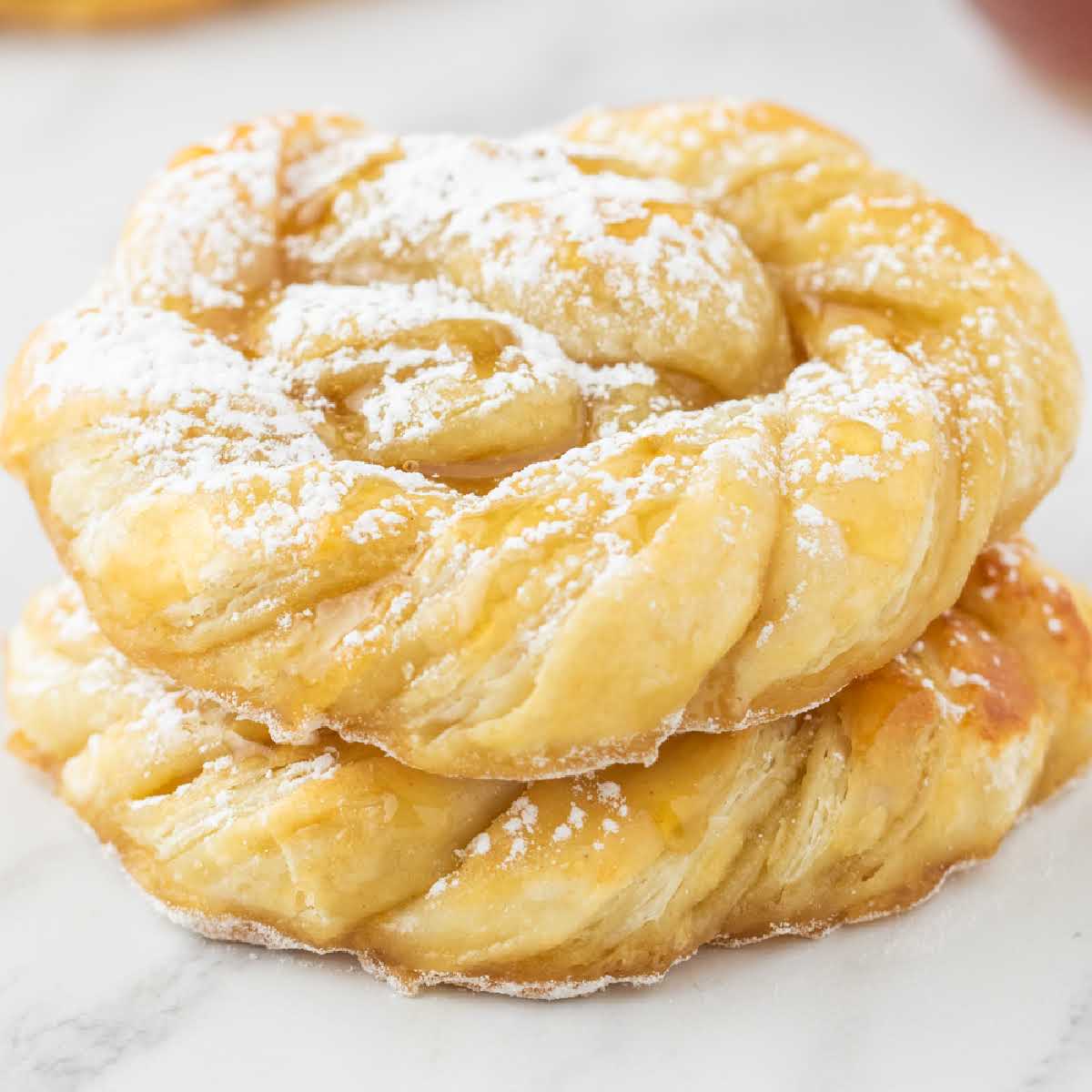 a close up shot of Baked Puff Pastry stacked on top of each other