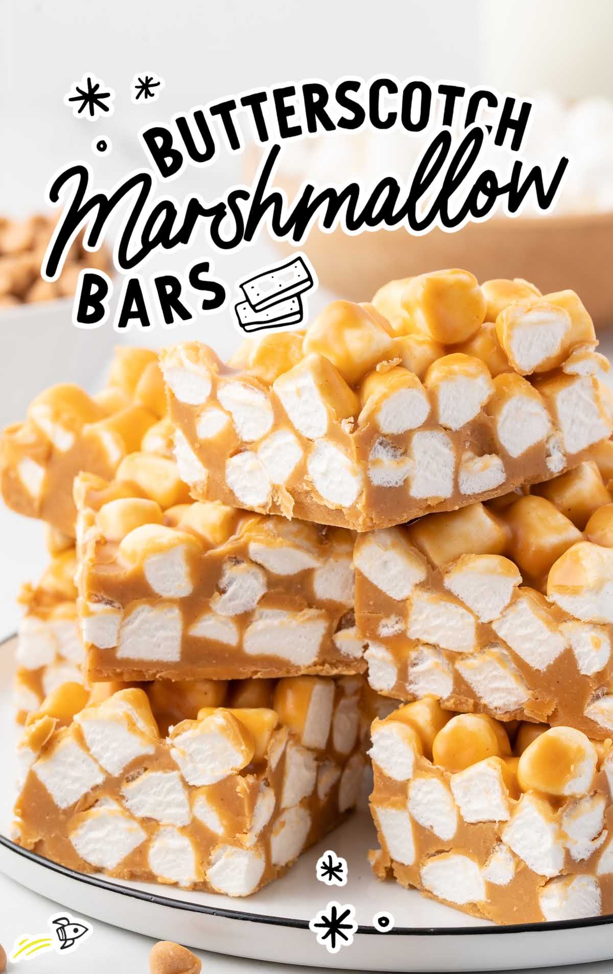 a close up shot of Butterscotch Marshmallow Bars stacked on top of each other on a plate