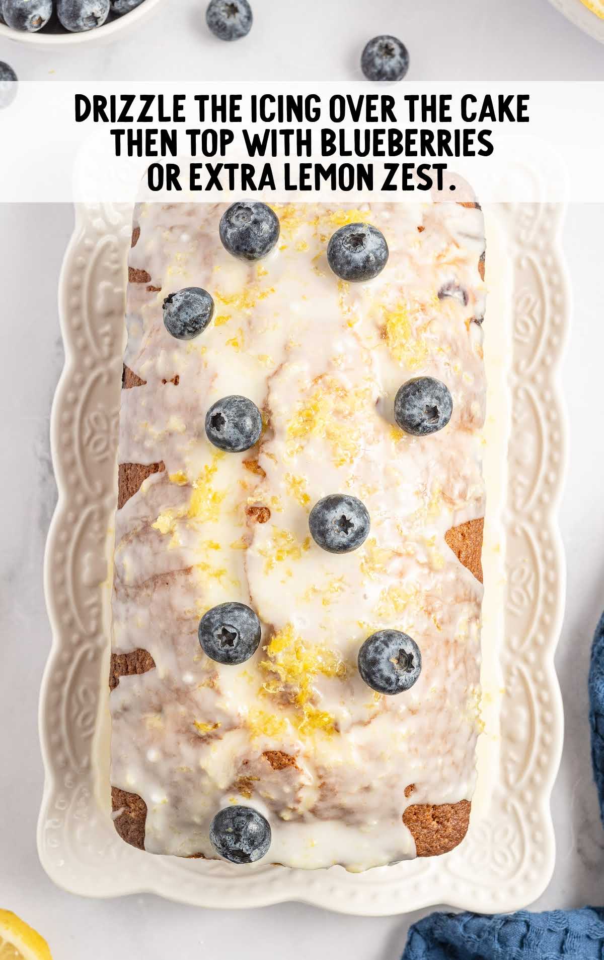 pound cake topped with glaze, blueberries, and lemon zest