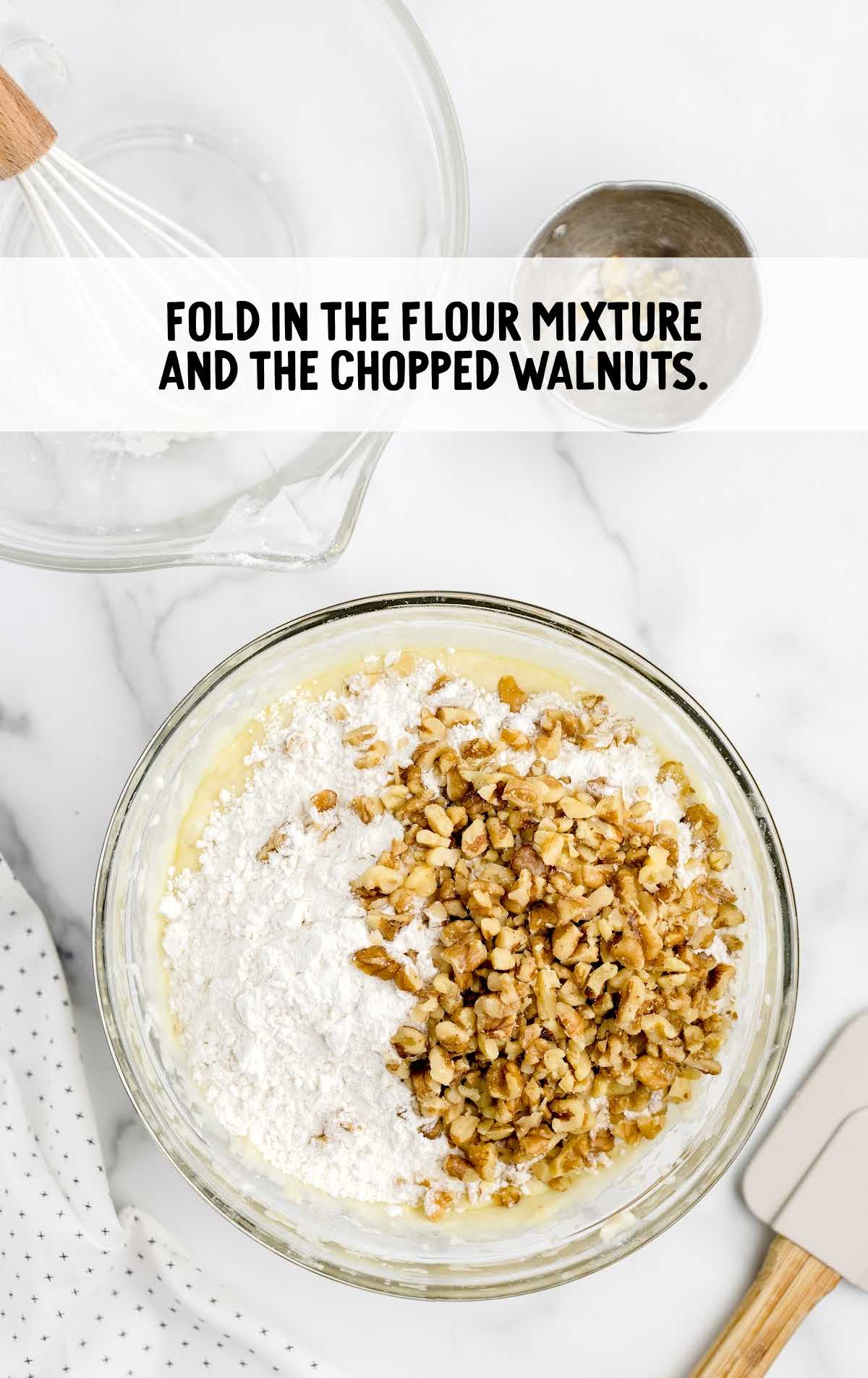 flour mixture added to the chopped walnuts in a bowl
