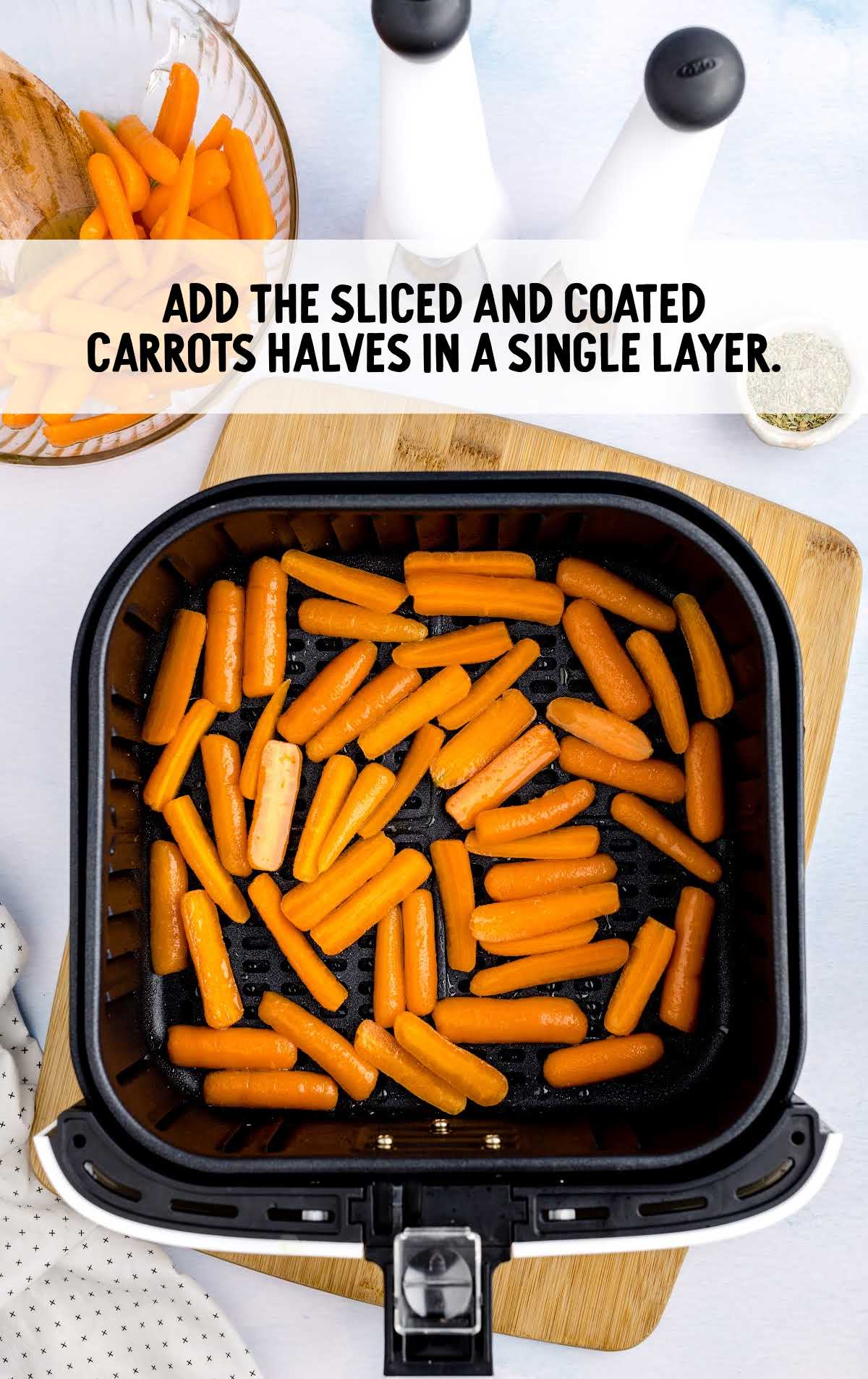 sliced and coated carrots halves added in a single layer