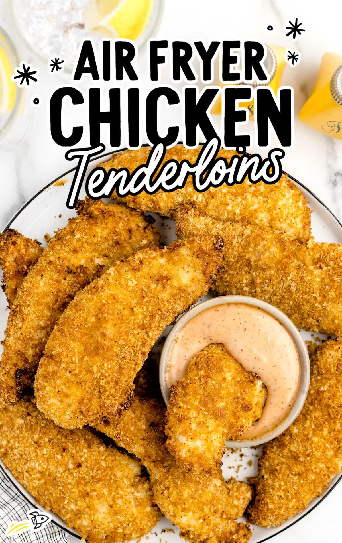 overhead shot of chicken tenders on a plate with a bowl of dipping sauce
